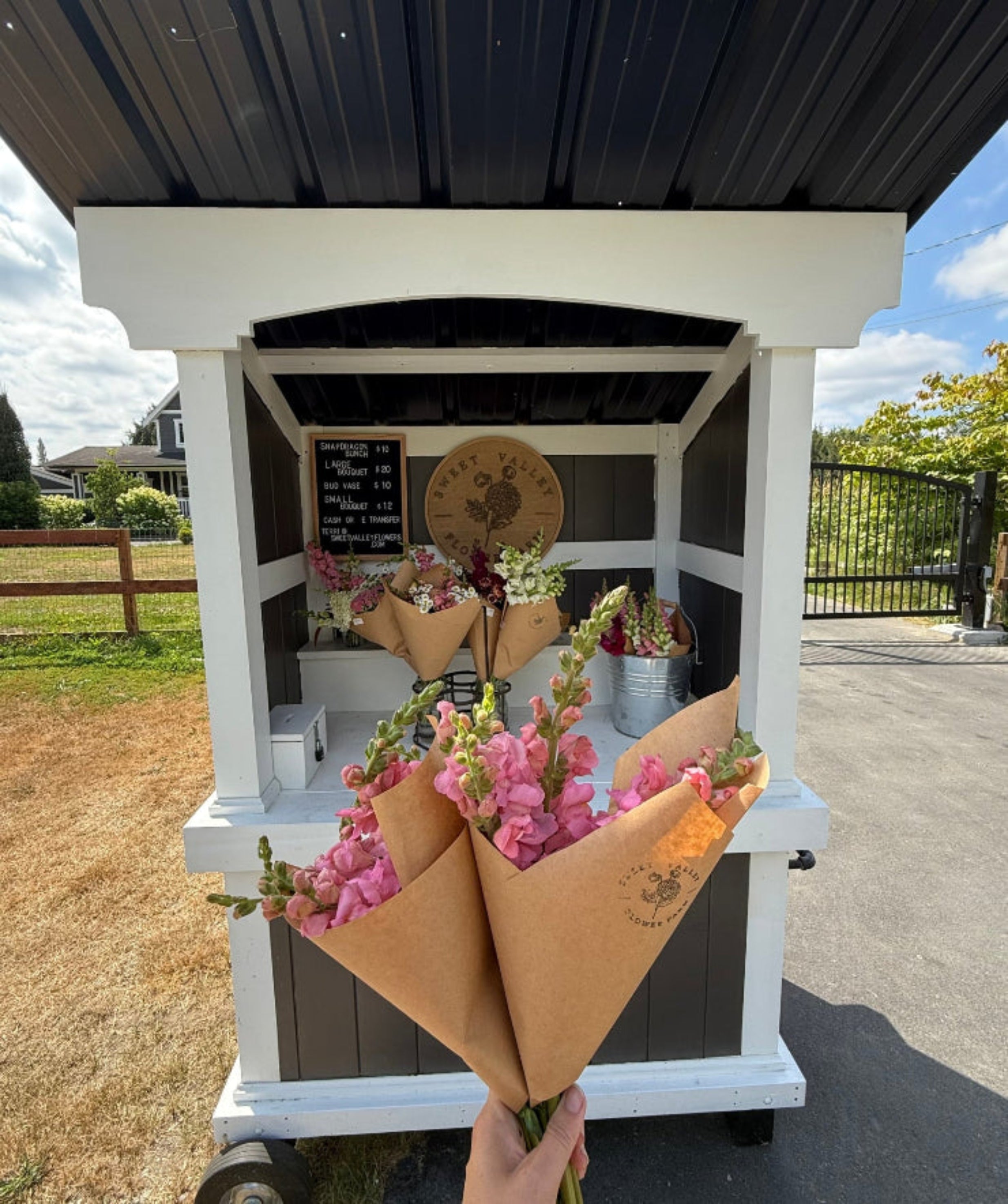 Flower stand in langley british columbia with bouquets being held in the front